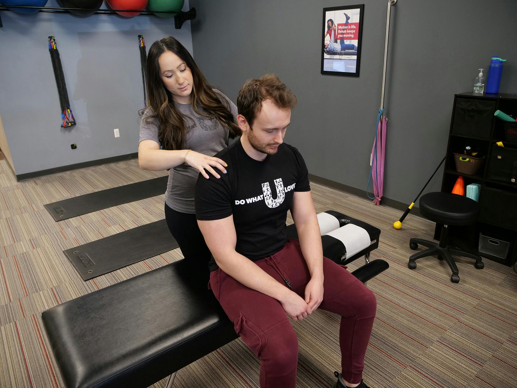 Chiropractor helping adjust a patient in clinic
