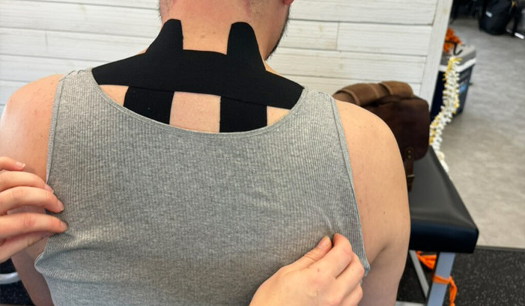 A patient at HealthSource of Downtown Mokena being treated with Kinesiology Tape.