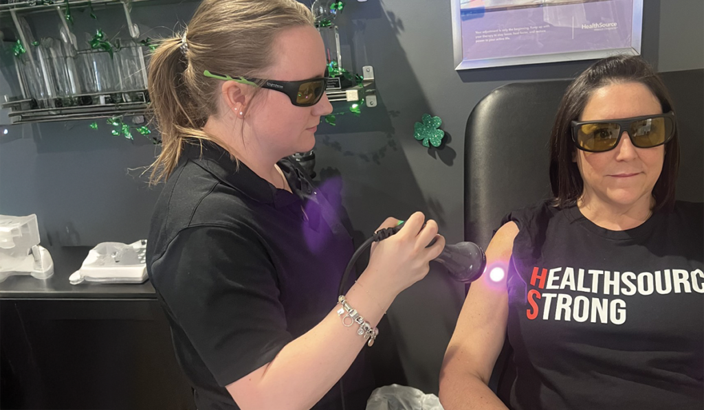 A patient at HealthSource of Troy receiving Laser Therapy treatment.