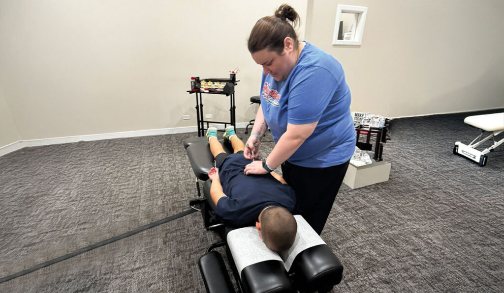 Dr. Katie Carlin at HealthSource of Chicago - Wicker Park adjusting a chiropractic patient.