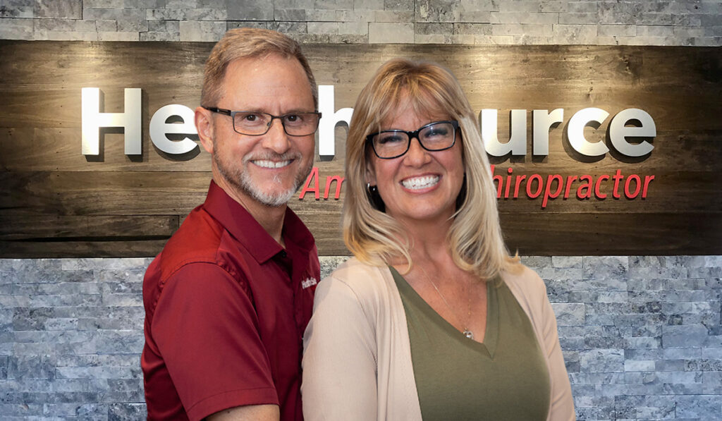 Dr. Ron Clifton and his wife Tonya, posing together in front of the HealthSource sign at HealthSource of Lebanon.