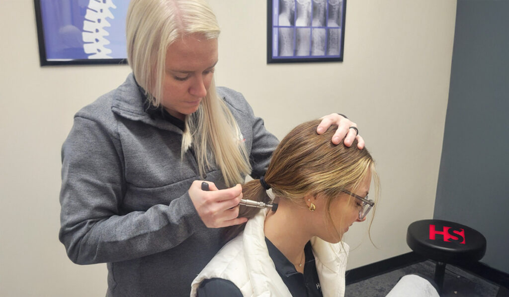 Dr. Fussy performing a chiropractic adjustment using the Activator method, on a patient at HealthSource of Mankato.