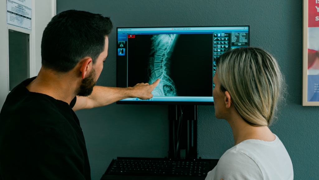 A doctor and patient evaluating X-ray results.