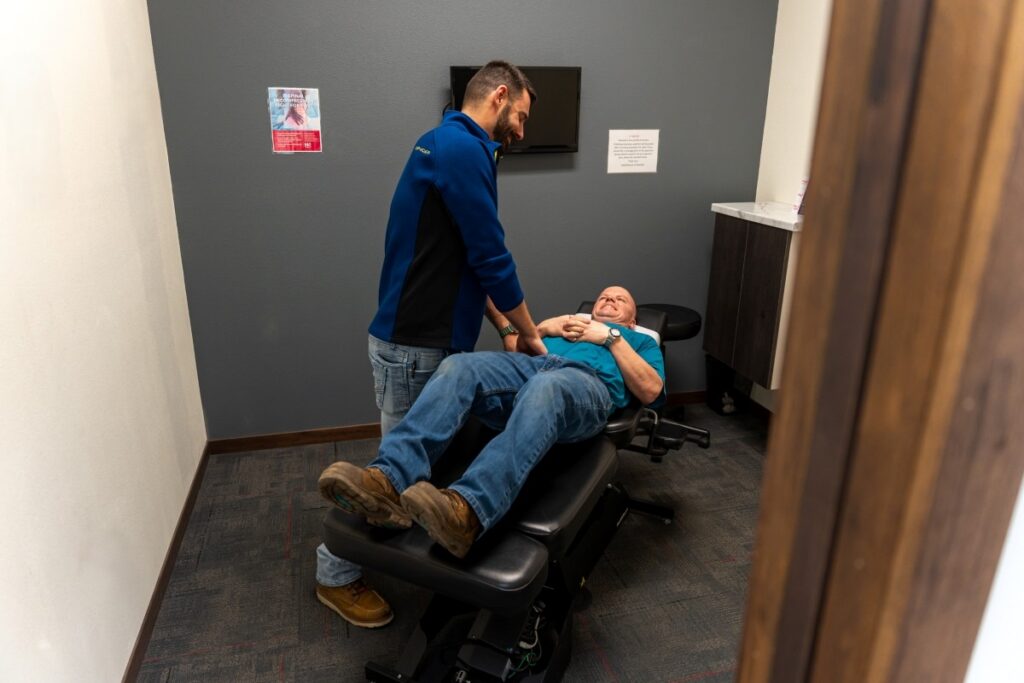 Dr. Robert Hennen, Doctor of Chiropractic, consulting with a patient at HealthSource of Marshall.
