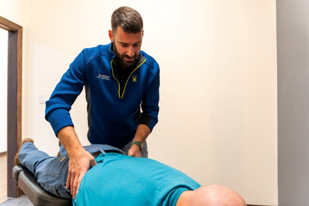 Dr. Robert Hennen, Doctor of Chiropractic, adjusting a patient at HealthSource of Marshall.