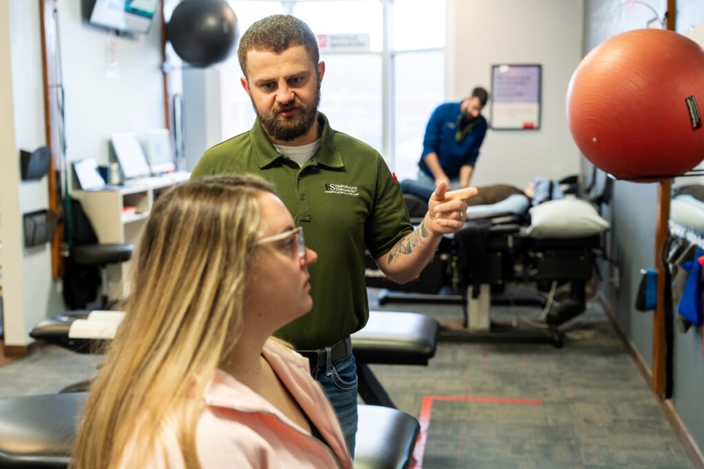 A Rehabilitation Specialist talking to a patient at HealthSource of Marshall.