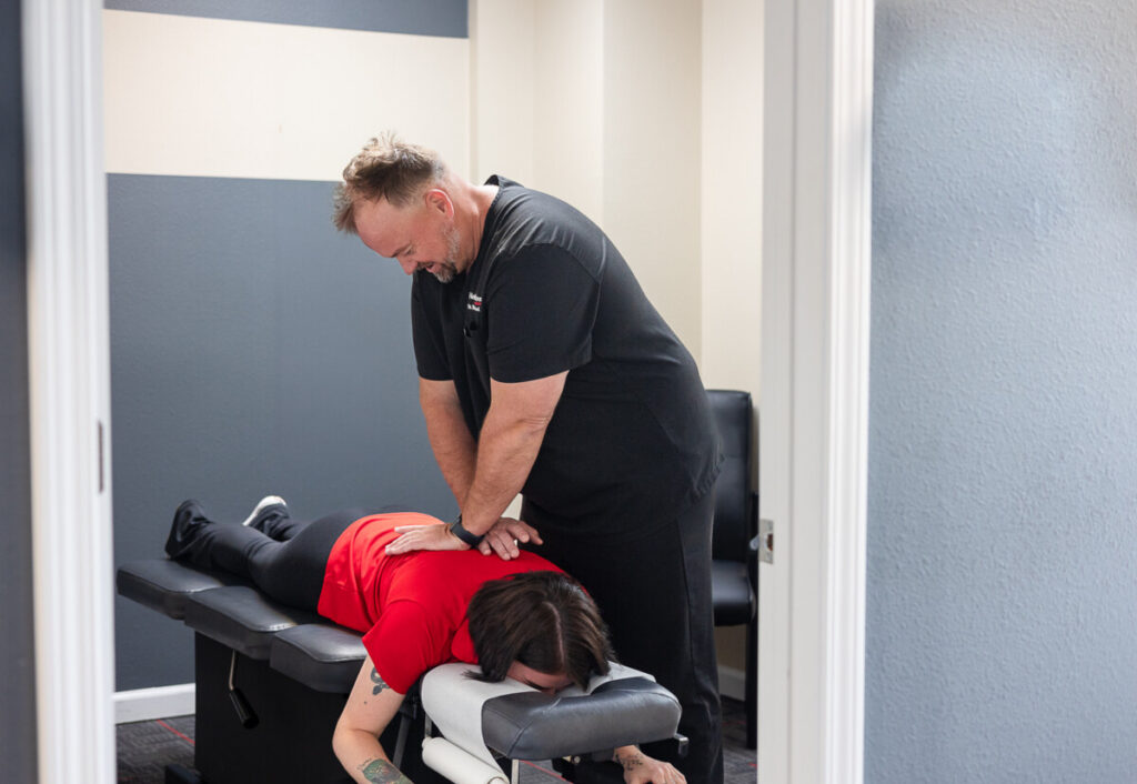 Dr. Michael Talley performing a chiropractic adjustment on a patient at HealthSource of Spanish Fort.