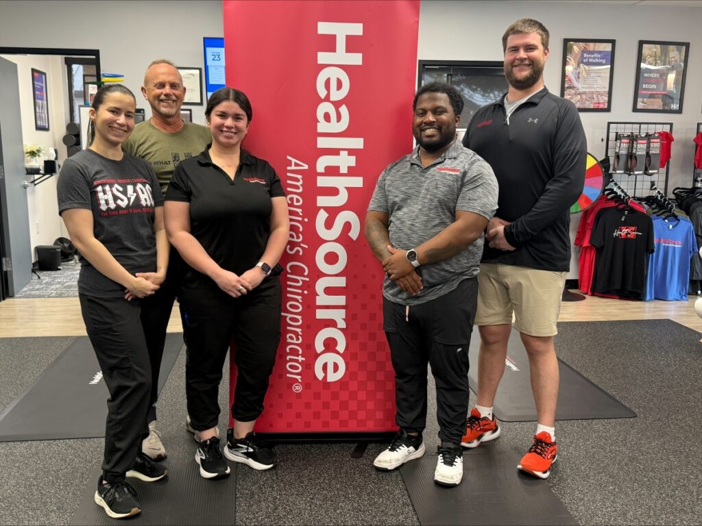 The HealthSource of Southwest Fort Worth team standing together inside the clinic.