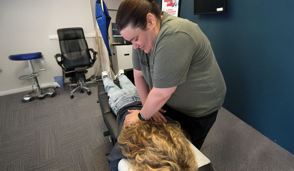 Dr. Katie Carlin at HealthSource of Chicago - Wicker Park adjusting a chiropractic patient.