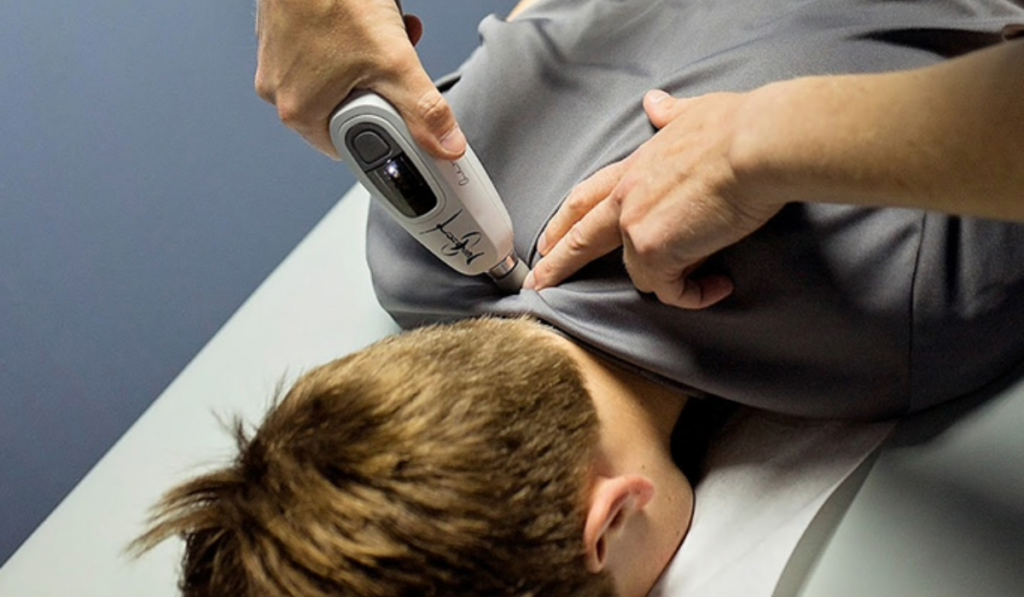 A chiropractic patient being treated using the Activator V.