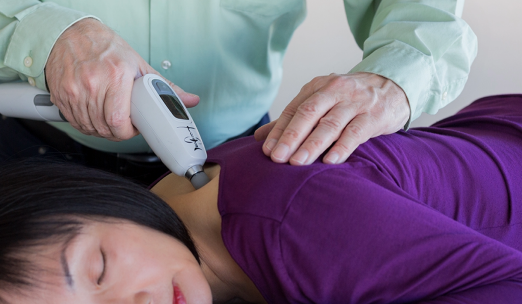 A chiropractic patient being treated using the Activator V.