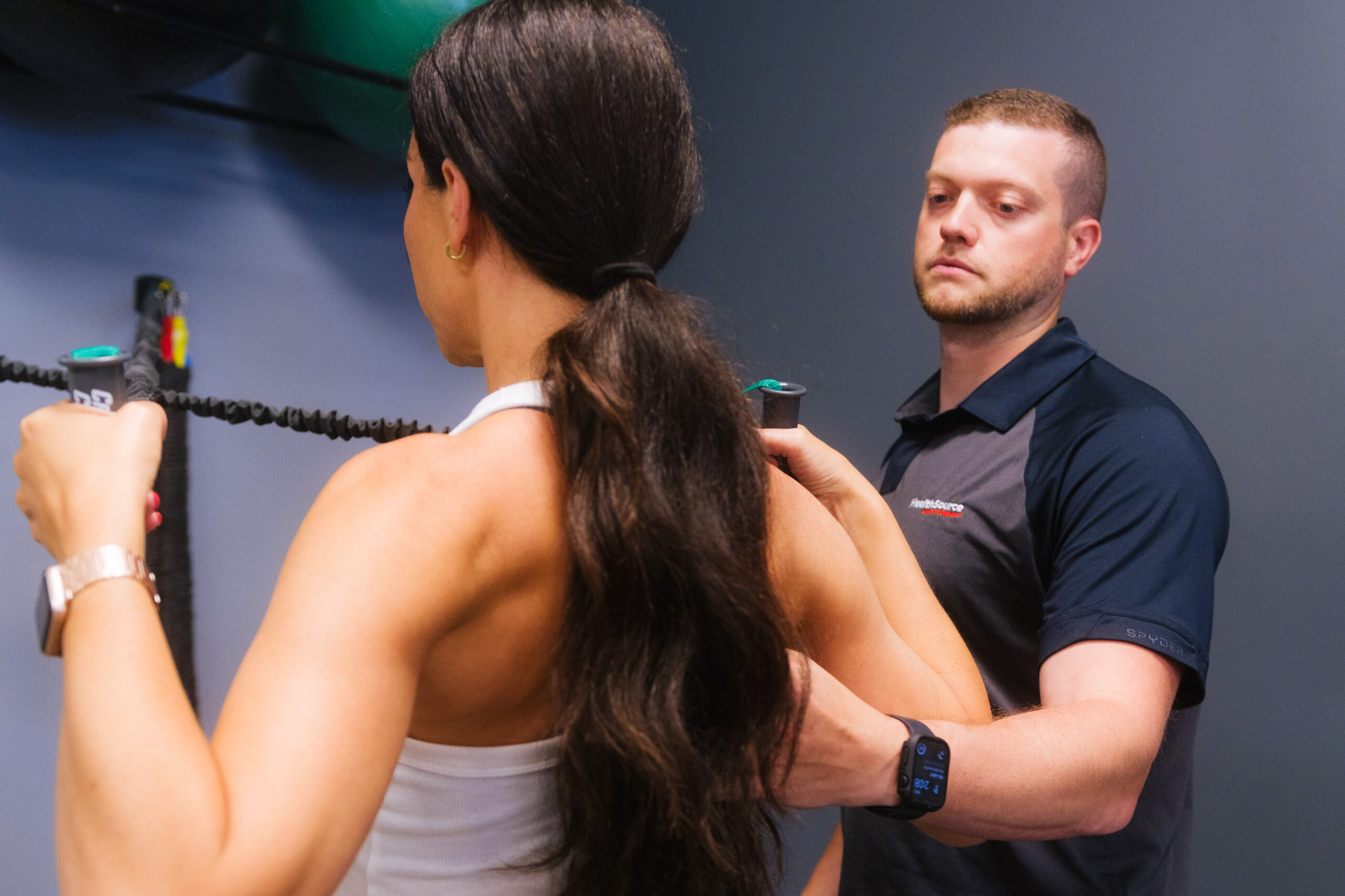 Practitioner works with patient as they exercise