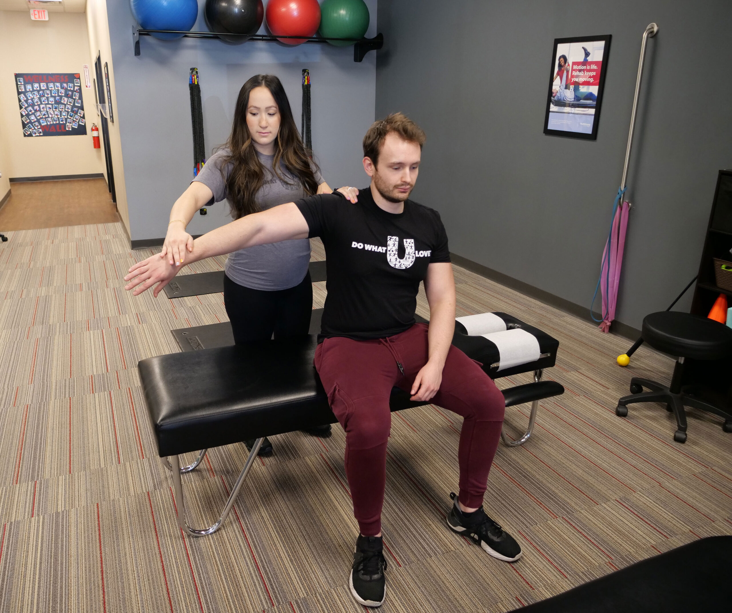 Team member works with client on exercise.