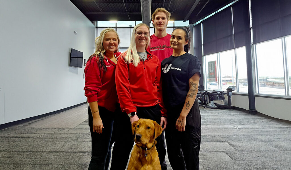Dr. Brittany Fussy, Doctor of Chiropractic, and the team at HealthSource of Mankato, posing together inside the clinic.