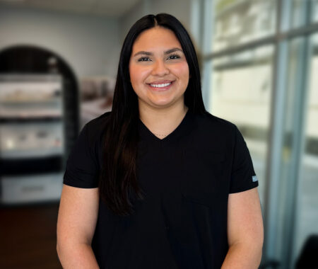Joanna Corona, a Rehabilitation Specialist at HealthSource of Muscle Shoals, posing inside the clinic.