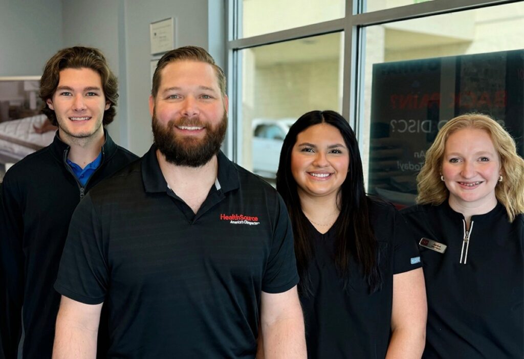 Dr. Jumper and the HealthSource of Muscle Shoals team posing together inside the clinic.