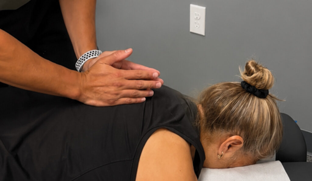 Dr. Giovanni Diaz performing a chiropractic adjustment on a patient at HealthSource of Burleson.