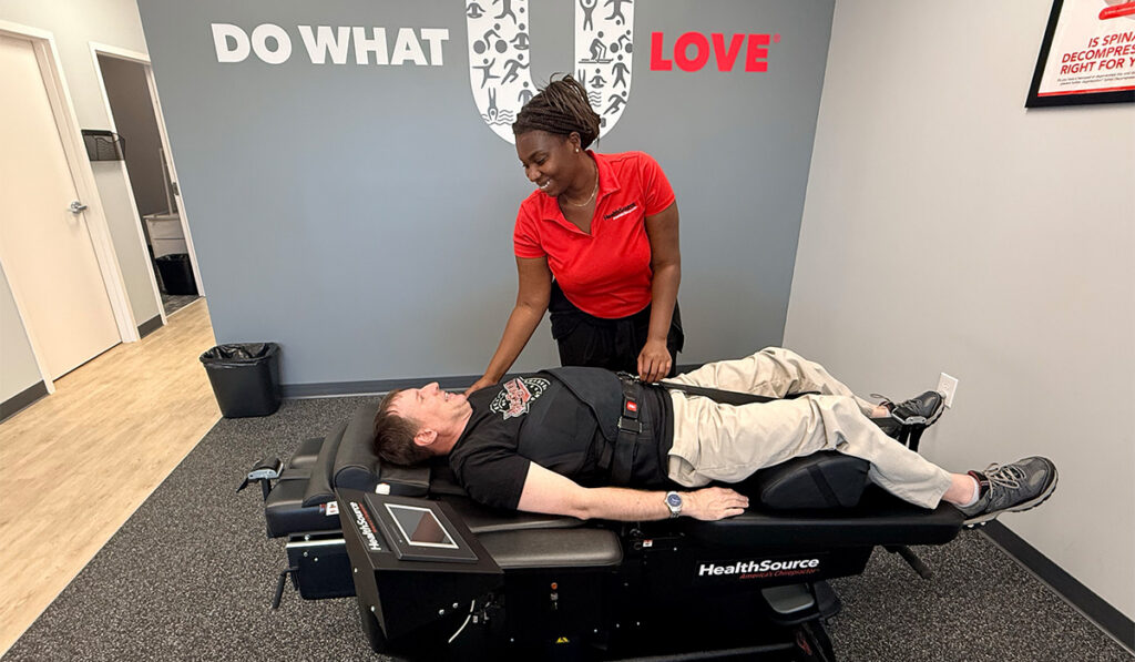 A patient laying on a Spinal Decompression table receiving treatment.