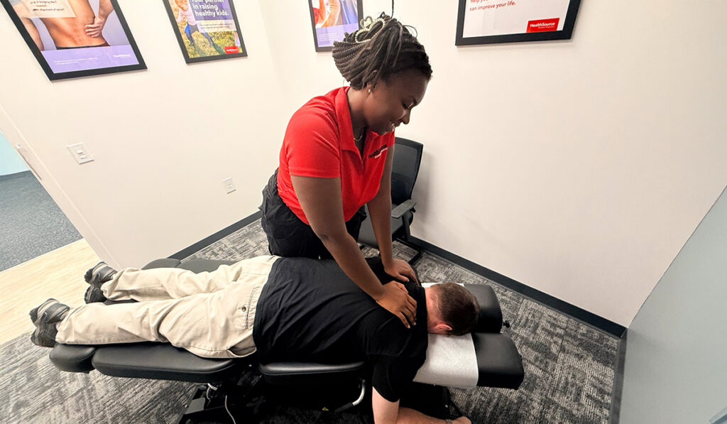 A chiropractor performing an adjustment on a patient.