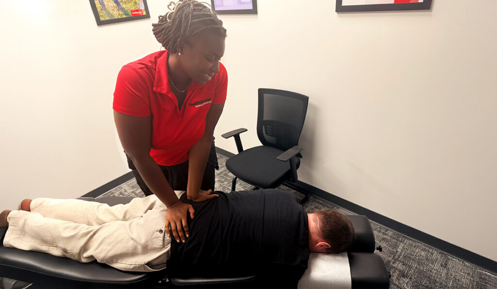 A chiropractor performing an adjustment on a patient.