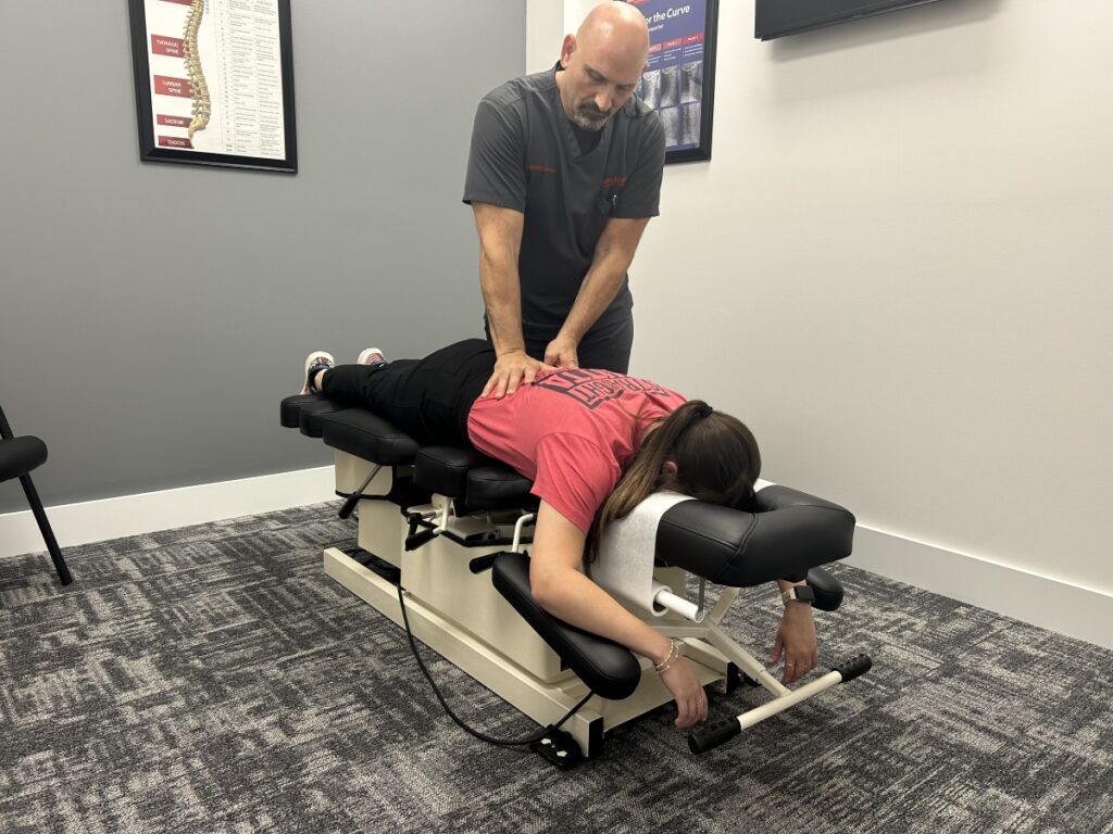 Dr. Joseph Lawrence with a chiropractic patient performing an adjustment.
